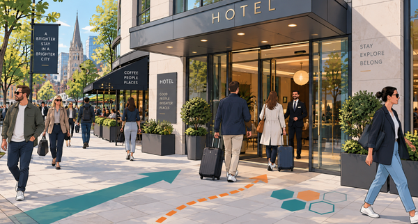 Travellers with suitcases walking past a city hotel entrance
